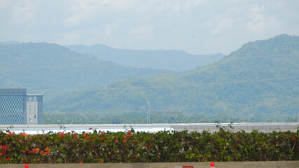 ​Modern Building and Scenic Mountain Range Landscape under Blue Sky