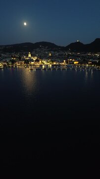 Cinematic drone footage of Como Lake at night with moonlight and city lights reflecting on the mirror-like water in vertical format for social media 3