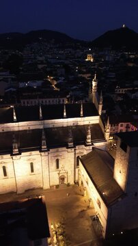 Spectacular vertical drone footage of Como Cathedral at night showcasing the illuminated dome and intricate statues with cinematic effects 2