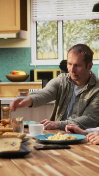 Vertical Video Stressed dad feeling disconnected and preoccupied ignoring daughter, needing a moment of peace and quiet. Being zoned out and distressed with worries, agitated anxious man. Camera A.