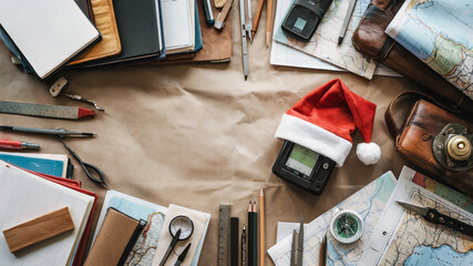 Holiday planning workspace with maps, tools, and Christmas decorations