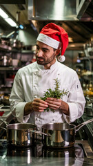 Chef wearing Santa hat in restaurant kitchen preparing festive meal