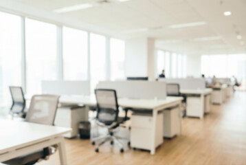 Blurred modern office interior with workstations and natural light