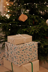 Wrapped gifts under Christmas tree with decorative lights and ornaments