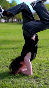 Breakdancer performing headspin and other moves in park