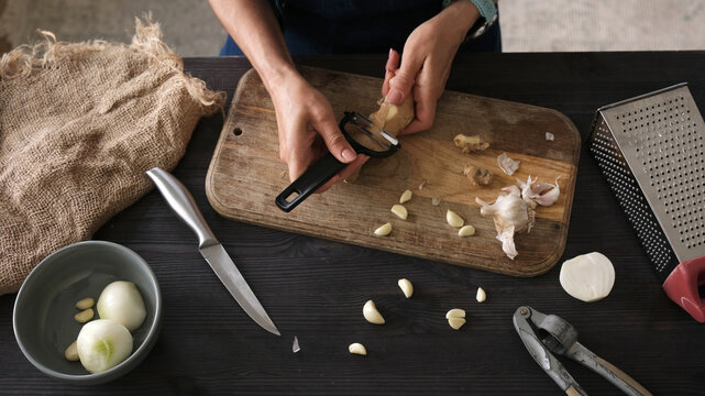 Close-Up Top View Of A Woman Peeling Ginger