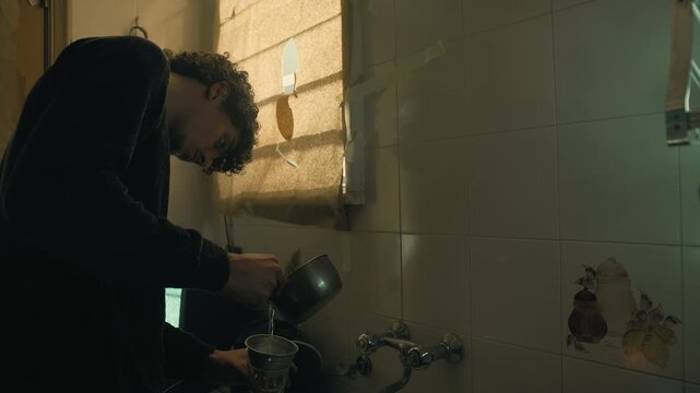 boy filters non-potable water from a strainer
