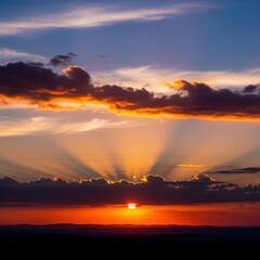 Dramatic sunset with sunbeams piercing through the clouds.