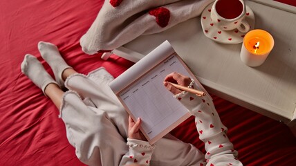 Cozy morning routine: planning the week with tea and a lit candle