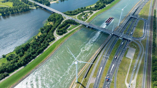 Aerial View of Inland Shipping Canal with Wind Turbines and Highway Bridge in Port of Rotterdam