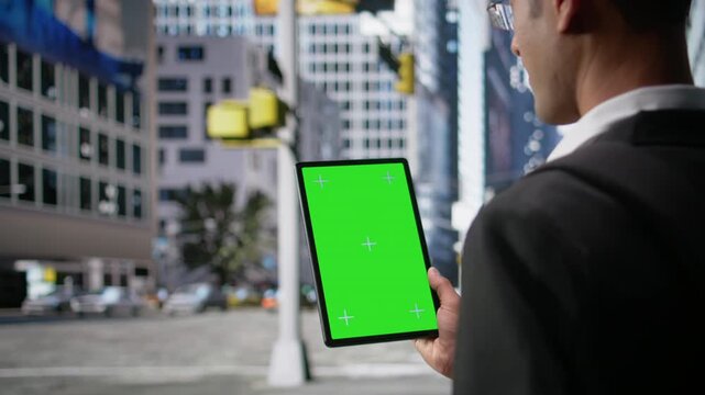 Vertical green screen on tablet with multicultural adults walking the business district, vibrant motion of big city routine with realistic movement capturing diverse pedestrians. Camera A.