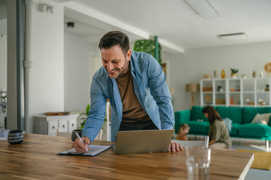 Father working from home balancing profession and family life