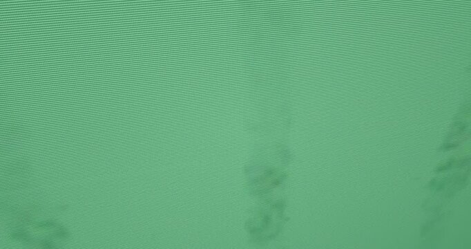 Faint puff trail forming top-left shifting rightward, growing, blurring, showing moire on clear bg