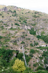 Fototapeta premium The ancient cave settlements and canyon of Khndzoresk, Armenia. Armenia mountainous landscapes with ancient cave habitations. 