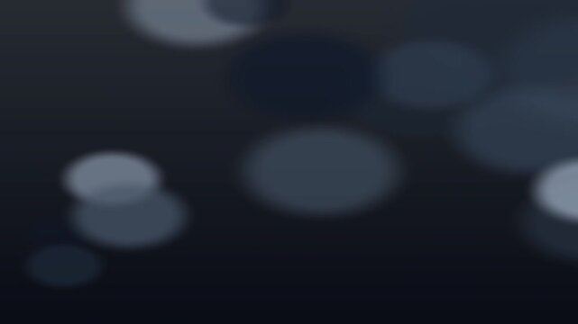 Closeup of glowing circular light patterns on dark surface with slow camera movement