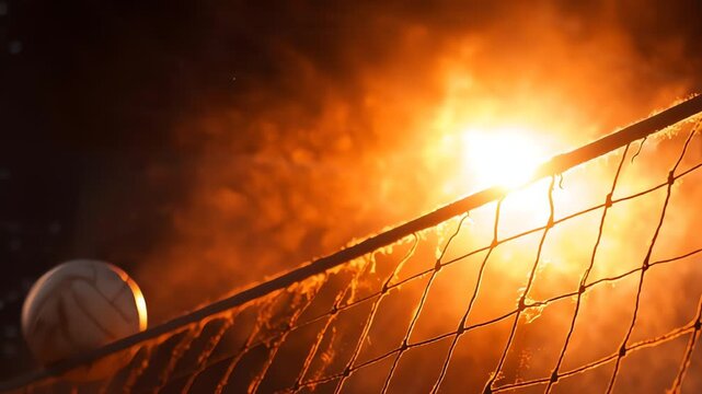 A volleyball rests near the net as the sun sets, casting a warm, orange glow.