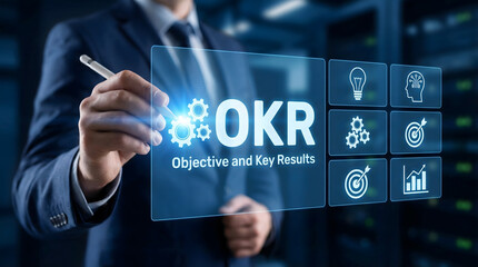 Professional man touching a glowing virtual OKR screen with Objective and Key Results text in a serv