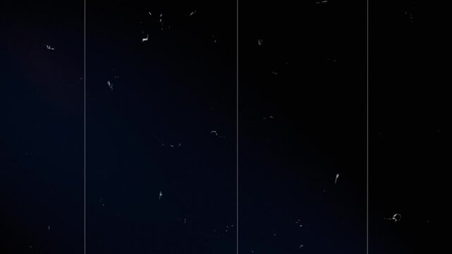 Vintage looping film strip background. 4K reel clutter old tv grain noise frame. Videotape texture overlay with scratches and dirt stains. Lens flare light leaks effect.