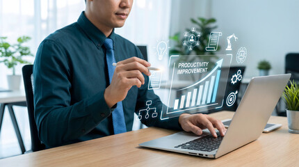 Focused businessman uses a laptop and holographic display showing productivity improvement in a mode
