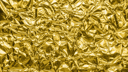Luxury shiny metallic golden foil crumpled texture background
