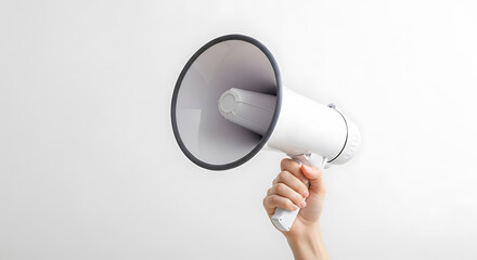 Person Holding a White Megaphone Against a Light Gray Background