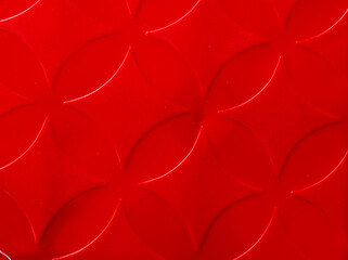 Vibrant red plastic surface with embossed diamond patterns, creating an impressive and modern 3D background texture