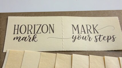 Obraz premium Creative Calligraphy Design on Vintage Paper with Inspirational Message about Horizon and Personal Steps