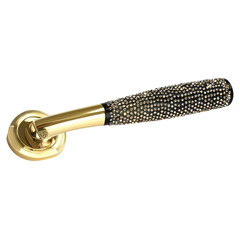 Luxury gilded doorknob sparkling with jewel accents isolated on white background