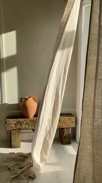 Wabi-sabi style interior featuring ancient clay pots on reclaimed wood and warm shadows
