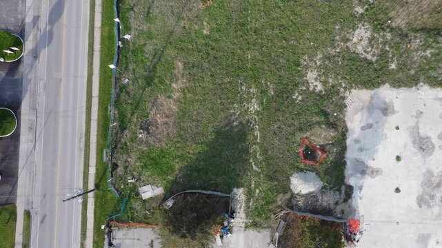 Drone flying over industrial area and vacant lot
