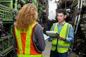 Workers working together in a warehouse environment, surrounded by shelves of organized items