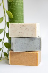 Stacked natural handmade soap bars with organic ingredients displayed on a clean minimal background for skincare and wellness concept
