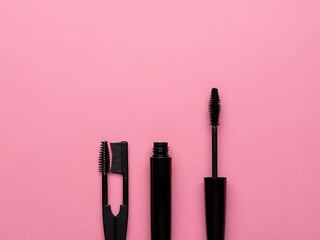 Obraz premium Mascara tubes and brushes arranged neatly on a pink surface from a top-down view