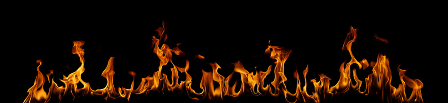 Bright orange fire flames isolated on black background, showing dynamic heat and energy movement. Perfect for design overlay, explosion effect, power, danger, and abstract background use.