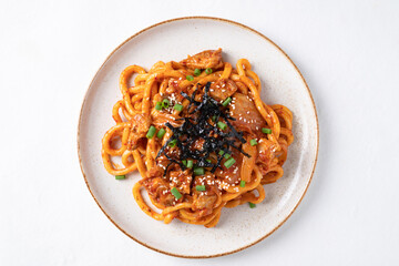 Top view of Stir fried Udon noodle with kimchi cabbage, pork, spring onion, sesame seed and seaweed on white background