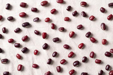 Azuki beans, Adzuki bean or red mung beans on white fabric background, Food ingredients in many Chinese dishes and filling in Japanese sweet