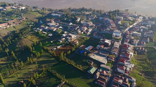 Cemoro Lawang village overlooking impressive Bromo Tengger Semeru park, aerial