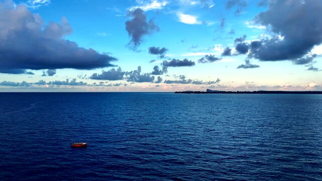 Traditional subsistence fishermen on boat in middle of azure Indian ocean, drone