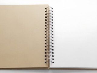 A spiral-bound notebook stands upright on a surface viewed from the side with a blank open page
