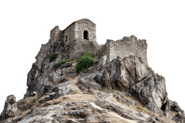 Ancient stone castle ruins perched on a rocky mountain isolated on transparent background. Ancient stone castle ruin on rocky cliff landscape scene isolated on white background.