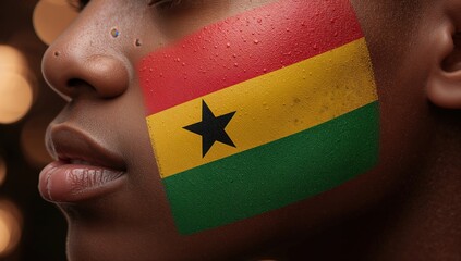 Close up man with Ghana flag painted on cheek, face paint