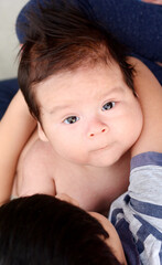 Latin boy holding his baby brother.