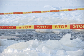 Ice Hazard Scene With Stop Tape Across Frozen Ground And Ice Chunks