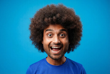 Joyful Man with Afro and Wide Smile on Blue Background