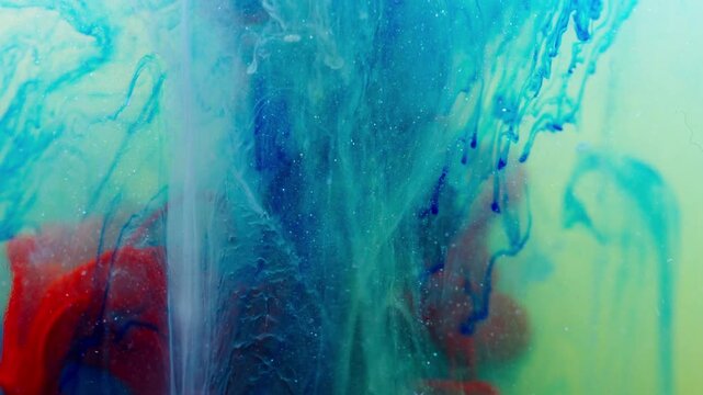 Colorful ink blends underwater, creating abstract art with vibrant flow