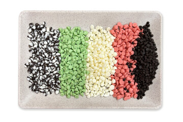 Colorful chocolate chips neatly arranged. Pastel and dark chocolate chips assortment. Colorful chocolate chips neatly arranged