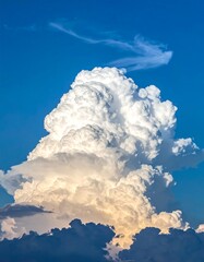A large white fluffy cloud in a clear blue sky
