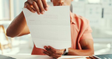 Hands, man and overdue document in office for payment required, invoice and finance reminder. Male...