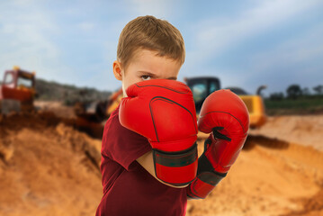 The boy appears to be angry and is ready to fight