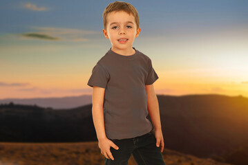 A young boy is pointing at a construction site